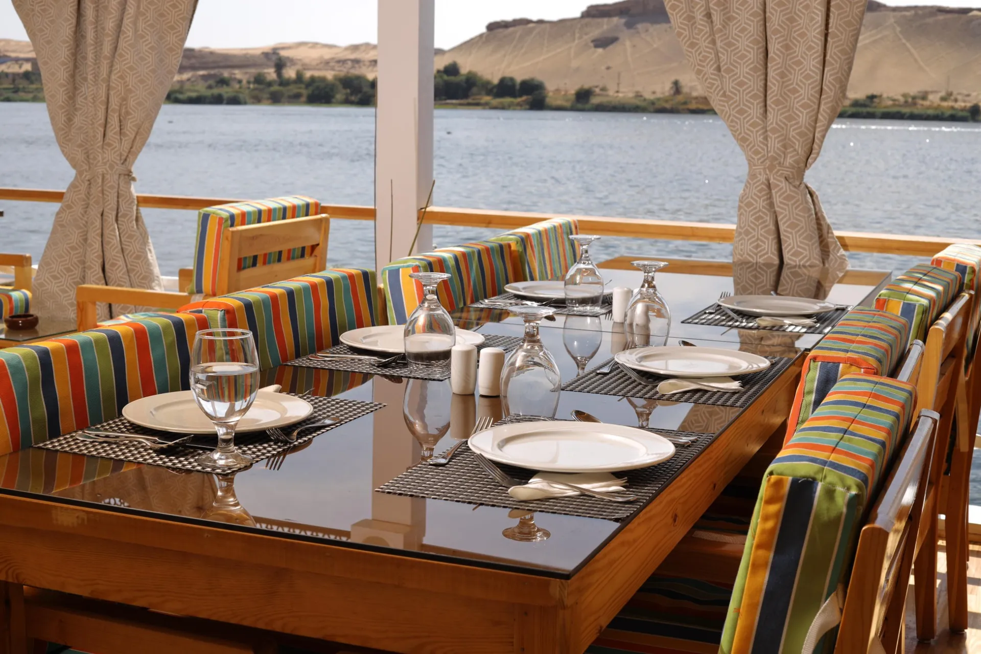 Dahabeya sailing past palm groves on the Nile